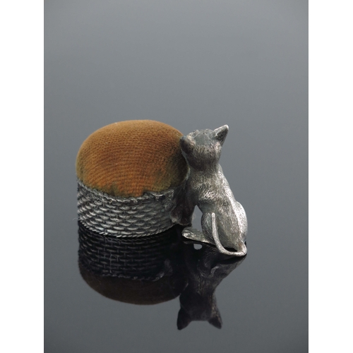 101 - A novelty white metal pin cushion, stamped mark for Mappin and Webb, modelled as a cat with a basket... 