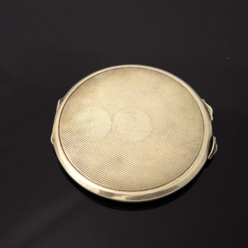 112 - A George VI silver and enamelled compact, Adie Brothers, Birmingham 1937, circular form with pale gr... 