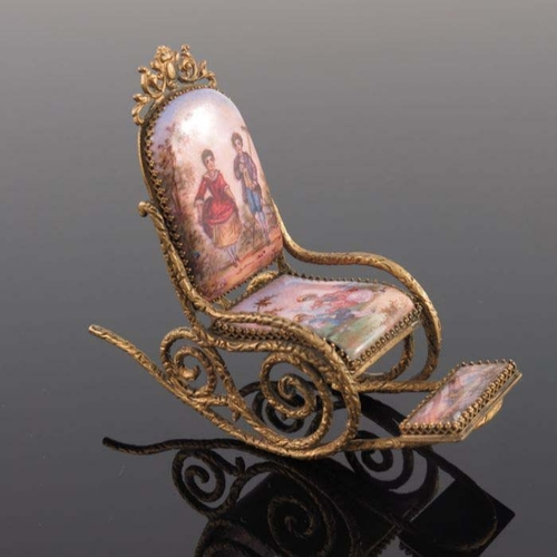 121 - A Continental gilt miniature rocking chair, the seat back, seat and footrest with figure and landsca... 