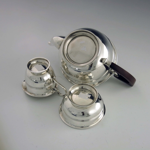 127 - A George V silver three piece tea set, Adie Brothers, Birmingham 1932/33, banded and rounded footed ... 