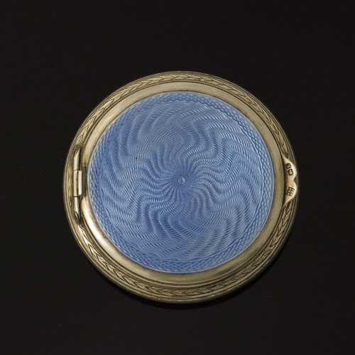 134 - A George V silver and enamelled compact, Charles S Green, Birmingham 1929, circular with inset hinge... 