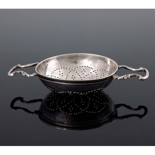 135 - A George II silver lemon strainer, William Justis, London 1737, the rounded bowl with fluted rim, pi... 