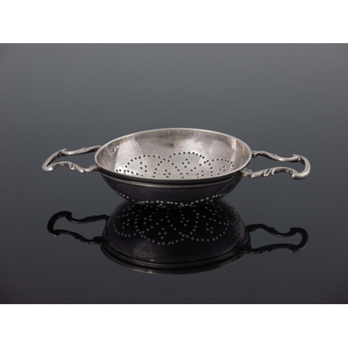 135 - A George II silver lemon strainer, William Justis, London 1737, the rounded bowl with fluted rim, pi... 