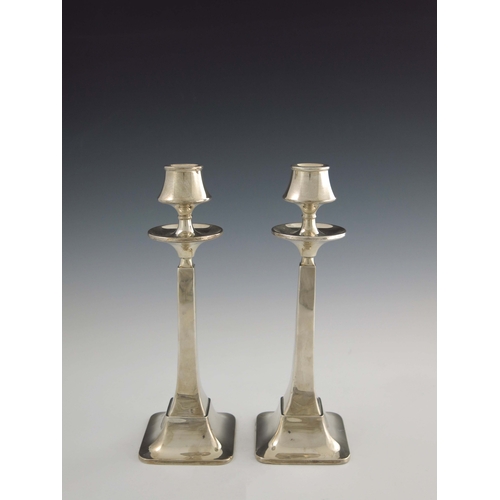 149 - A pair of Arts and Crafts silver candlesticks, W G Sothers Ltd., Birmingham 1923, square section spl... 