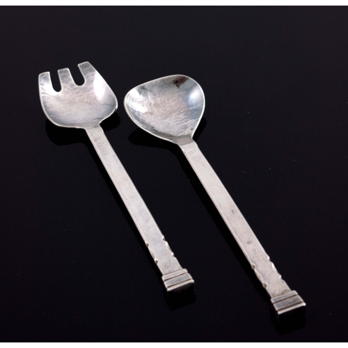 152 - Guild of Handicrafts, a pair of Arts and Craft silver salad servers, London 1939, planished and notc... 