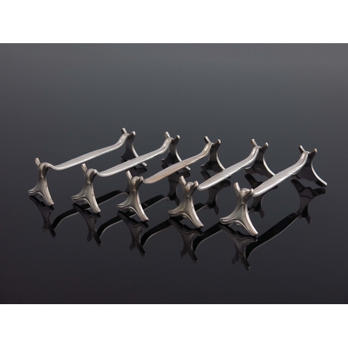 154 - A set of twelve Art Nouveau silver plated knife rests, Christofle, circa 1910, each of sinuous organ... 