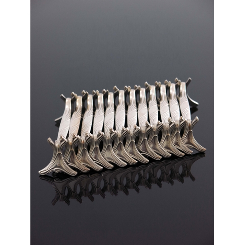 154 - A set of twelve Art Nouveau silver plated knife rests, Christofle, circa 1910, each of sinuous organ... 