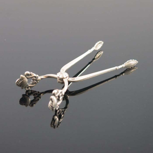 155 - Johan Rohde for Georg Jensen, a pair of sterling silver sugar tongs, pierced and stylised acorn hand... 