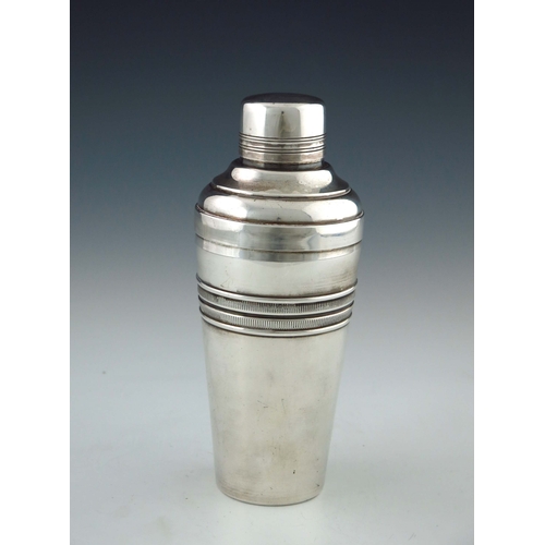 160 - An Art Deco silver plated cocktail shaker, conical form with central ribbed band, stepped shouldered... 