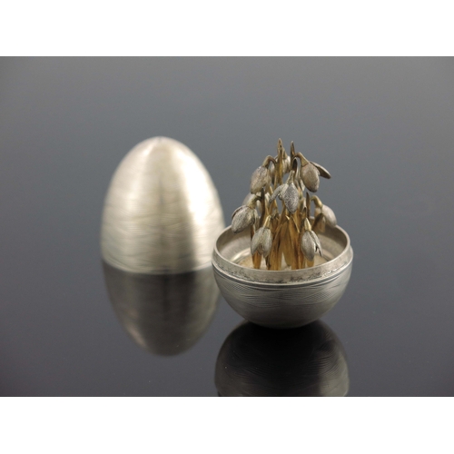 173 - A Modernist silver novelty surprise egg, Peter Nicholas and Co., London 1988, textured engine turned... 