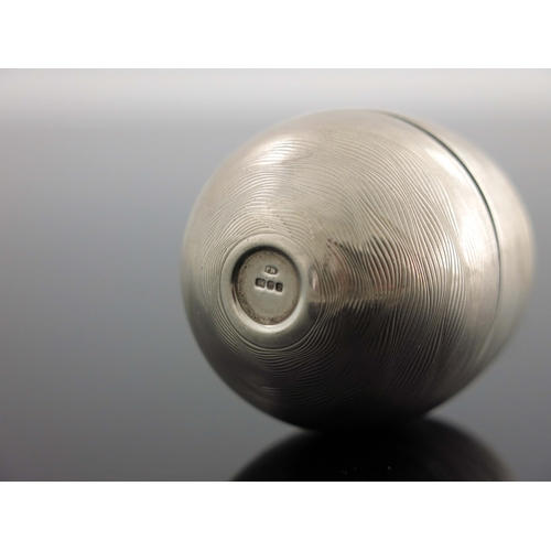 173 - A Modernist silver novelty surprise egg, Peter Nicholas and Co., London 1988, textured engine turned... 