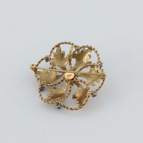 176 - A 14 carat gold, pearl and sapphire brooch, the central stone within radiating leaves and open ropet... 