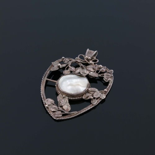 184 - An Arts and Crafts silver and mother of pearl pendant, in the style of John Paul Cooper, heart shape... 