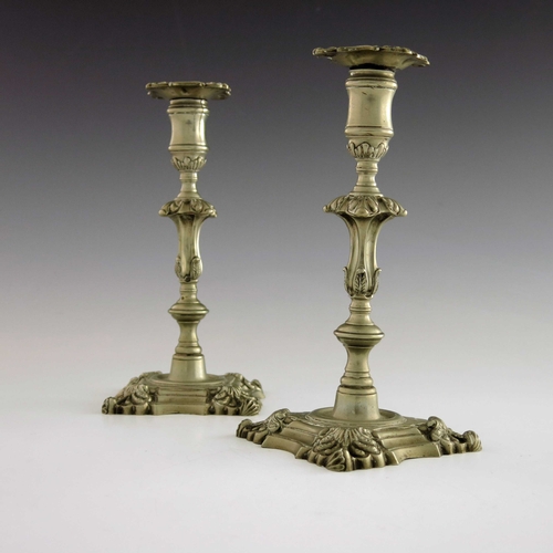 1 - A pair of 18th century Paktong candlesticks, circa 1760s, knopped foliate baluster form, on ogee flu... 