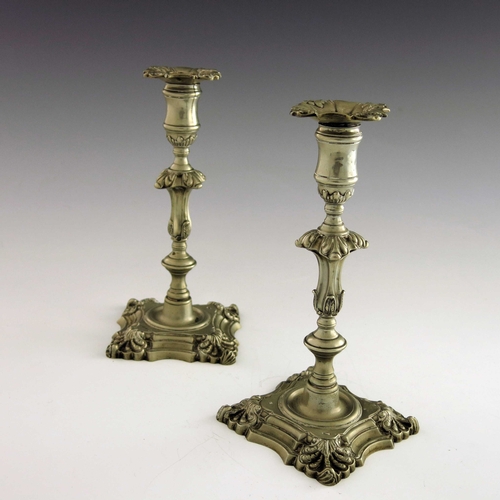 1 - A pair of 18th century Paktong candlesticks, circa 1760s, knopped foliate baluster form, on ogee flu... 