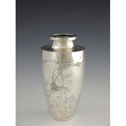 10 - A Japanese silver vase, 20th century, shouldered form, embossed and engraved with an eagle in flight... 