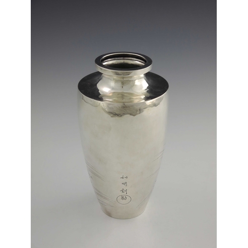 10 - A Japanese silver vase, 20th century, shouldered form, embossed and engraved with an eagle in flight... 