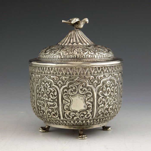 16 - An Indian Kutch silver box and cover, or tea caddy, 19th century, rounded bowl form, repousse emboss... 