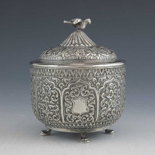 16 - An Indian Kutch silver box and cover, or tea caddy, 19th century, rounded bowl form, repousse emboss... 