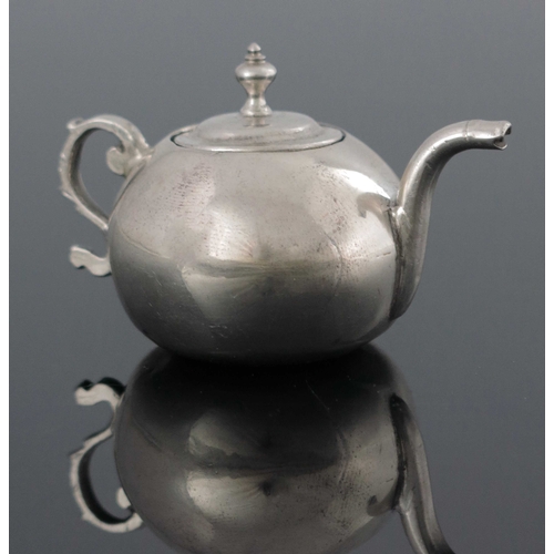 18 - A Dutch miniature silver teapot, Amsterdam 1755, spherical form with ogee lid, foliate S scroll hand... 