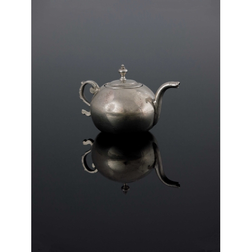 18 - A Dutch miniature silver teapot, Amsterdam 1755, spherical form with ogee lid, foliate S scroll hand... 