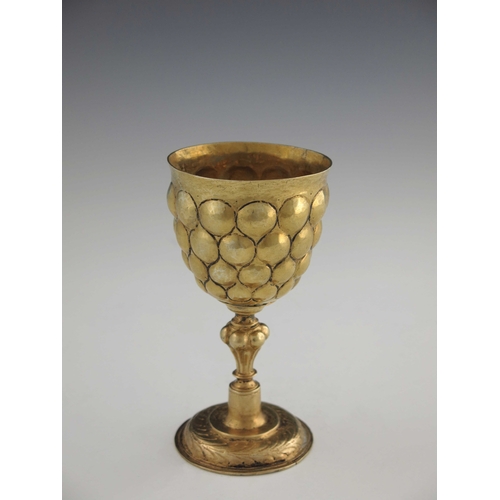 21 - A 17th century German silver gilt goblet, probably Nuremberg circa 1620, the rounded cup with emboss... 