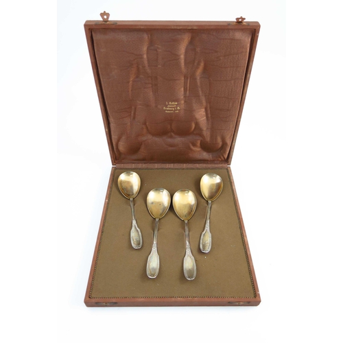 22 - A set of four German silver fruit serving spoons, circa 1910, beaded and floral design with gilt bow... 