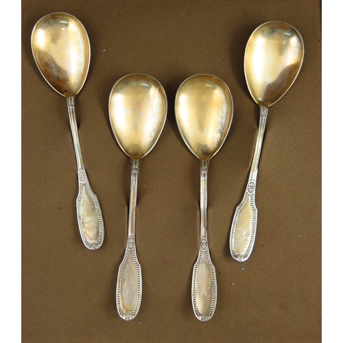 22 - A set of four German silver fruit serving spoons, circa 1910, beaded and floral design with gilt bow... 