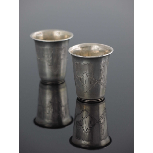 26 - A near pair of Ukrainian silver and parcel gilt beakers, Kiev circa 1890, flared form, engraved with... 