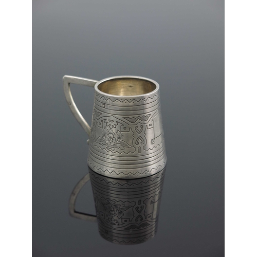 27 - An Imperial Russian silver mug, Aleksandr Fuld, Moscow 1880, conical form, engraved with geometric a... 