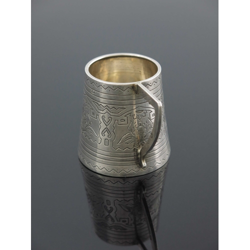 27 - An Imperial Russian silver mug, Aleksandr Fuld, Moscow 1880, conical form, engraved with geometric a... 