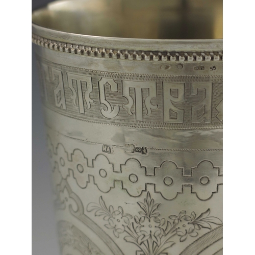 29 - A large Imperial Russian silver footed beaker, Moscow 1879, conical form, chased and engraved with w... 