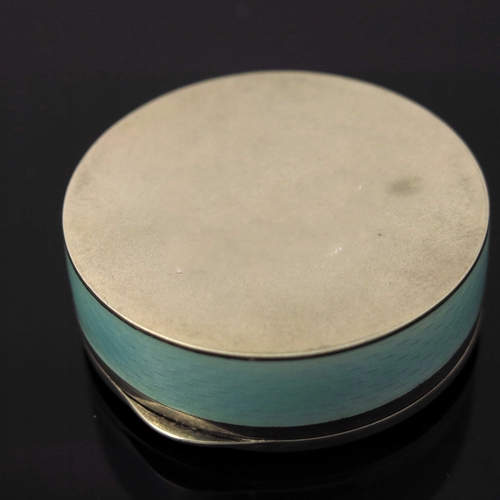 31 - A Continental silver and enamelled box, circular, blue guilloche enamel body, the lid with a painted... 