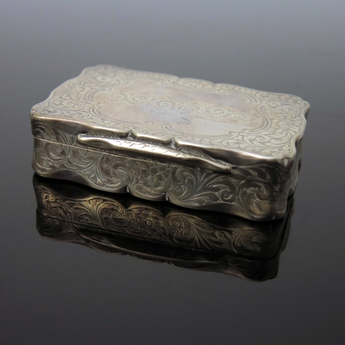 41 - A Victorian silver snuff box, Owen and Boon, Birmingham 1855, ogee bordered rectangular form, chased... 