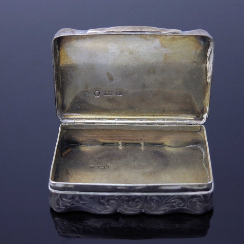 41 - A Victorian silver snuff box, Owen and Boon, Birmingham 1855, ogee bordered rectangular form, chased... 