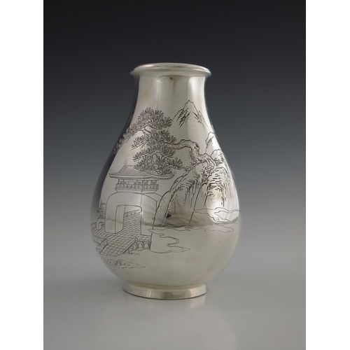 8 - A Japanese silver vase, 20th century, baluster form, engraved with a mountain landscape scene of tem... 