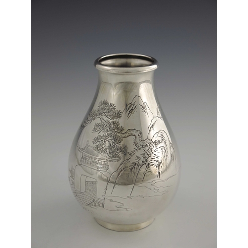 8 - A Japanese silver vase, 20th century, baluster form, engraved with a mountain landscape scene of tem... 