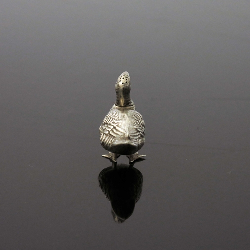 76 - An Edwardian novelty silver pepper pot, Birmingham 1903, modelled as a duck, standing, with removabl... 