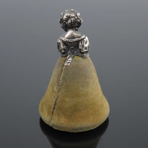 97 - A George V novelty silver pin cushion, Saunders and Shepherd, Chester 1911, in the form of a woman w... 