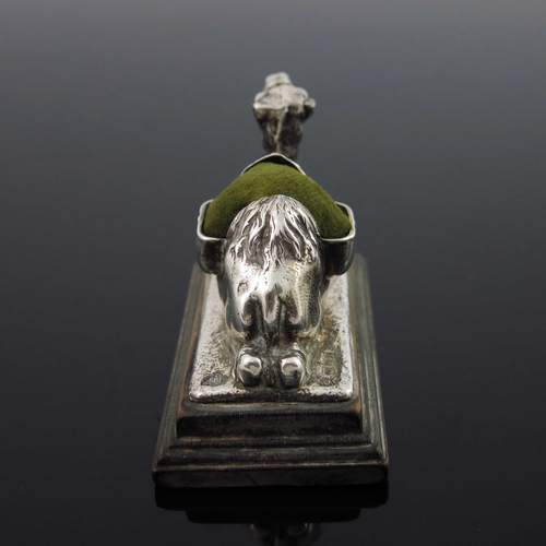 98 - An Edwardian novelty silver pin cushion, Carrington and Co., London 1904, cast in relief as a camel,... 