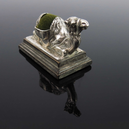 98 - An Edwardian novelty silver pin cushion, Carrington and Co., London 1904, cast in relief as a camel,... 