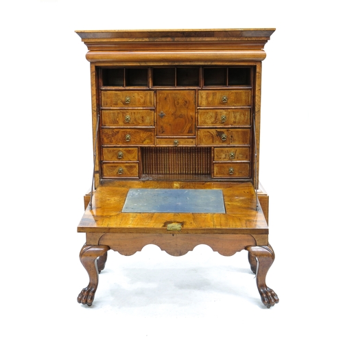 343 - A figured walnut bureau on stand of Queen Anne design, plain moulded cornice with a cushion frieze d... 