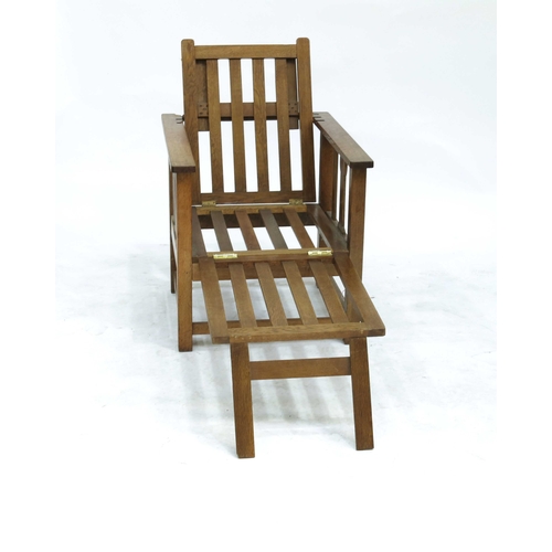 356 - An Arts & Crafts oak metamorphic armchair, circa 1910, adjustable slatted backrest, sides and retrac... 