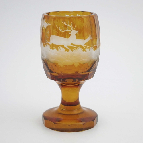 372 - A Bohemian etched and engraved glass goblet, facet cut and amber washed, decorated with a hunting sc... 