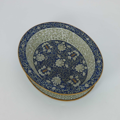 429 - A Chinese reticulated oval basket on matching stand, blue enamel decoration of scrollwork, white fol... 