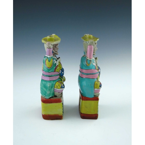 440 - A pair of Chinese coloured enamel porcelain candle holders, in the form of smiling bearded men in ro... 