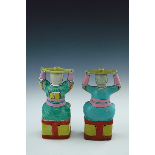 440 - A pair of Chinese coloured enamel porcelain candle holders, in the form of smiling bearded men in ro... 