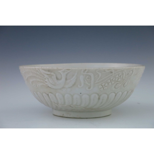 442 - A Chinese blanc de chine footed bowl, the frieze with moulded design of exotic birds in flight, gadr... 