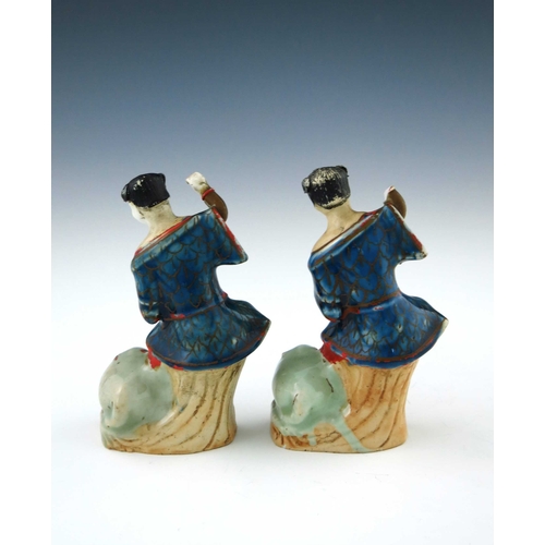 443 - A pair of 18th Century Chinese porcelain figurines, modelled as joyful and playful boys upon a stump... 