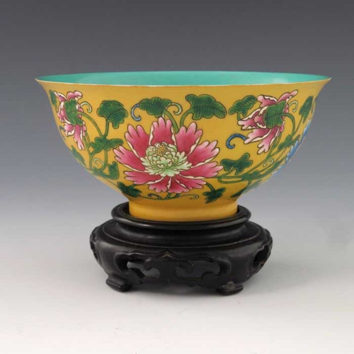 448 - A Chinese polychrome bowl, Kangxi mark, ogee form, yellow ground, enamelled with flowers and scrolli... 